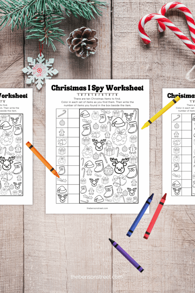 A table with free printable christmas item i spy pages on it with crayons to color in