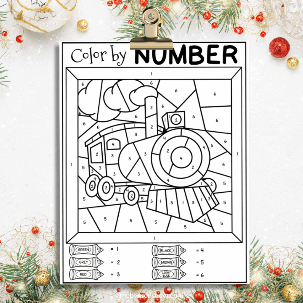 Clipboard with a polar express train color by number page on it ready to color in