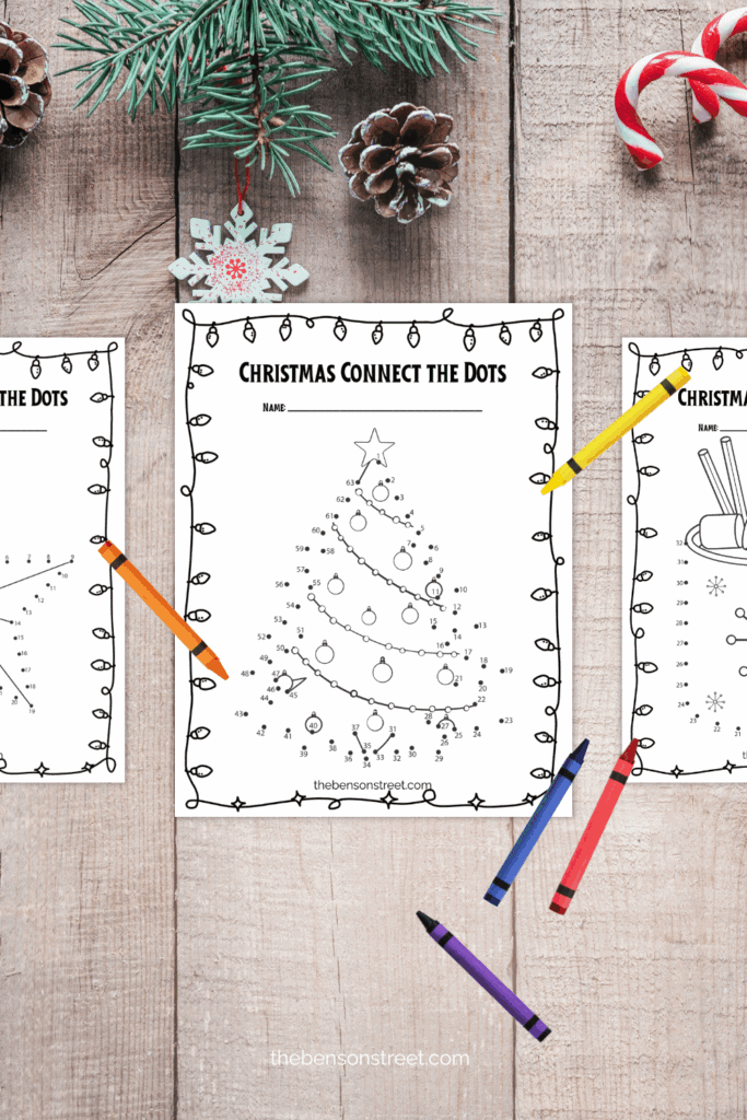 Three pages of christmas dot to dot images with crayons on top