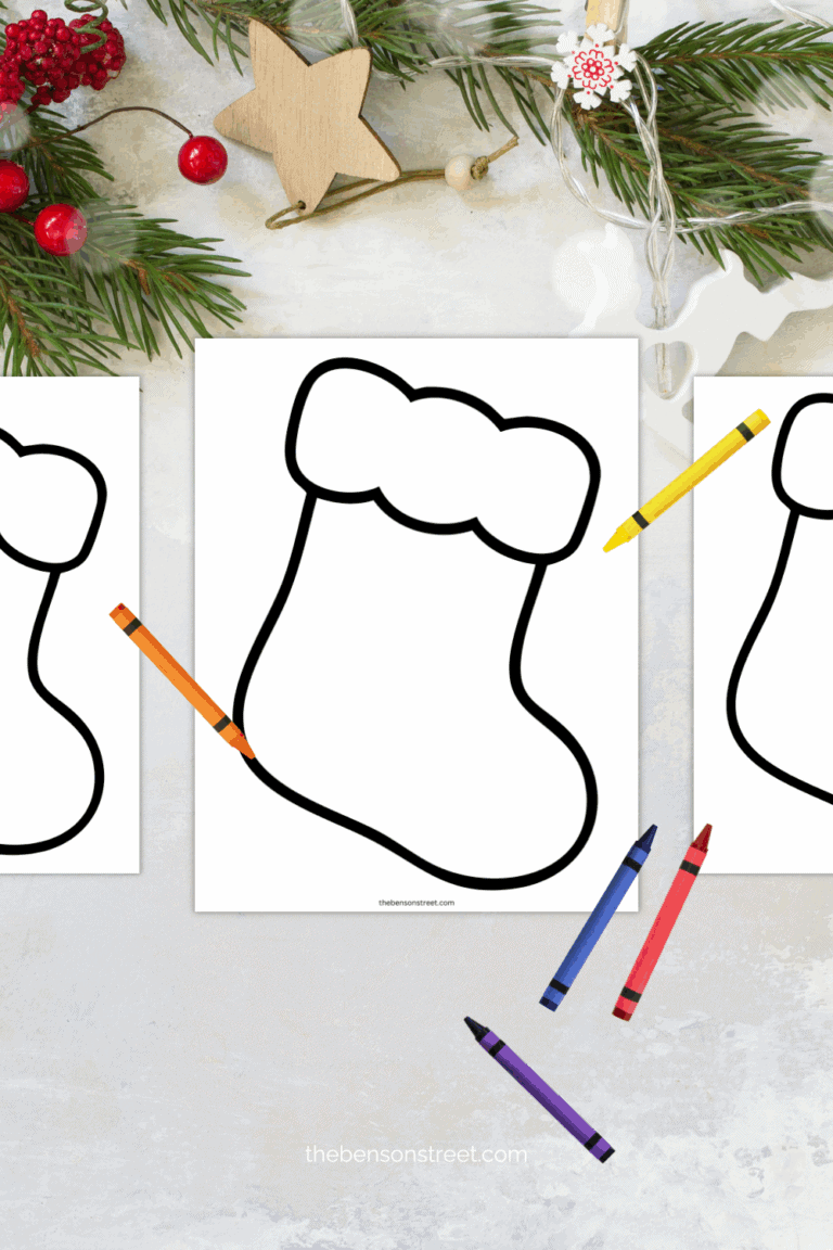Coloring crayons laying around a christmas decorated table with printable stockings to color