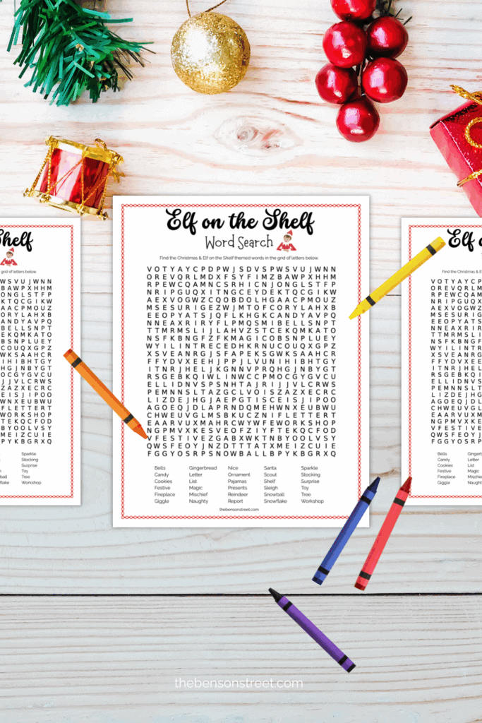 Elf on the shelf word search on a table with crayons around