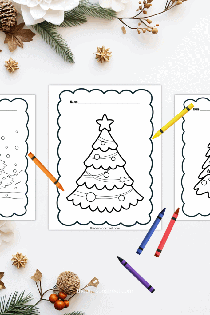 Three christmas coloring sheets with crayons laying around
