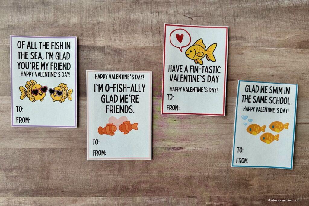Four goldfish tags printed out on a wood background