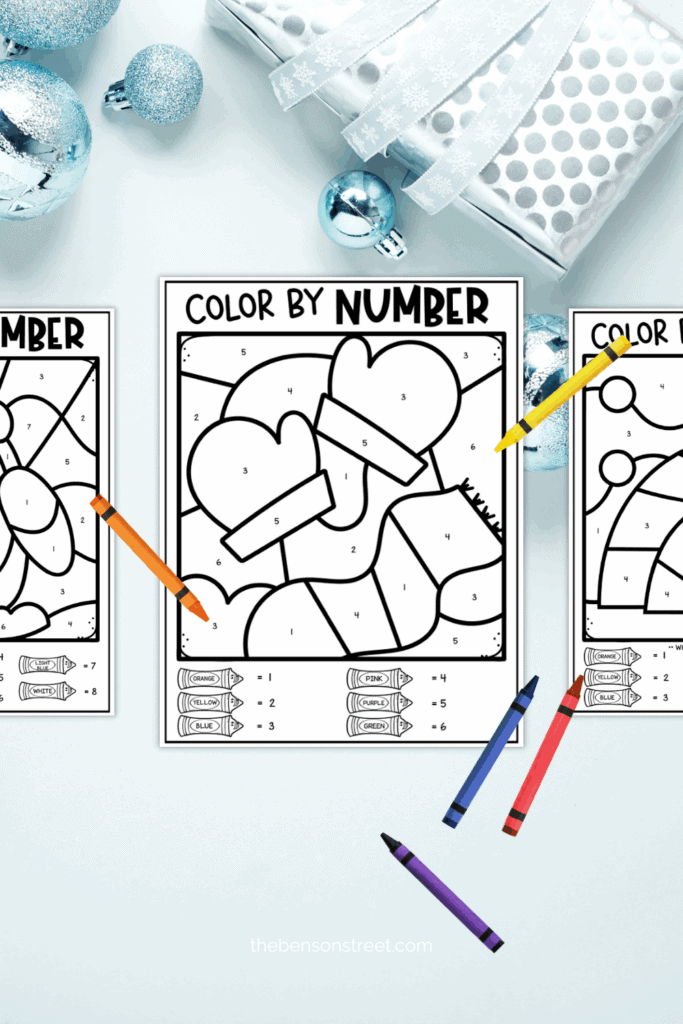 Three free color by number pages with crayons around on a blue background 