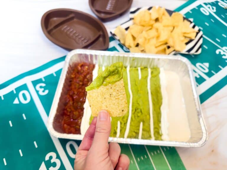 Chip with guacamole on it for an easy football game day dip