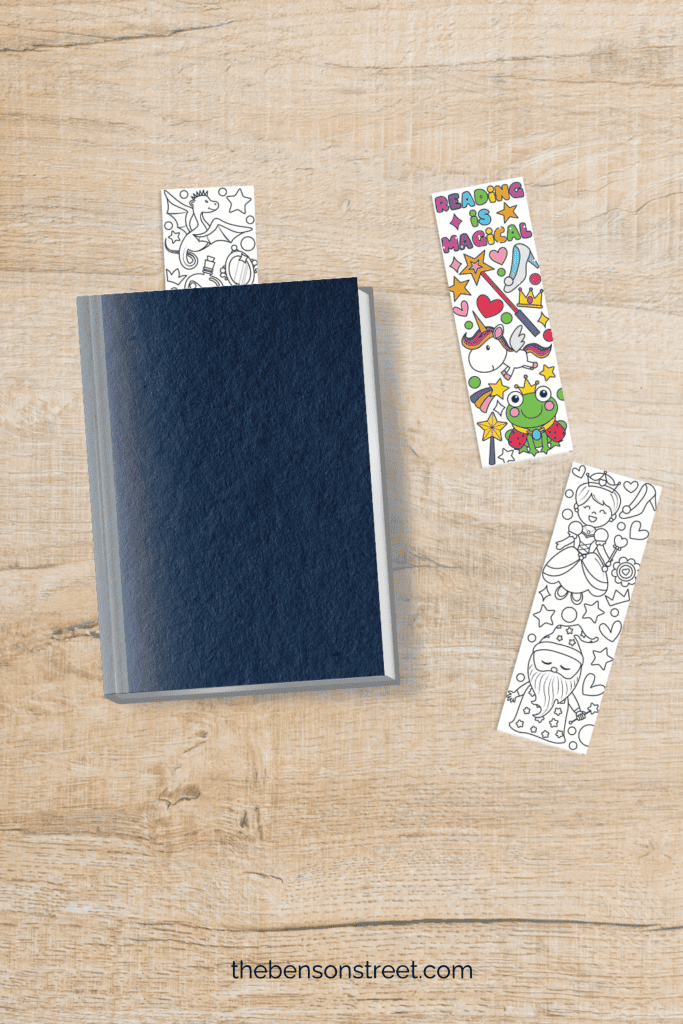 Fairy Tale Themed Coloring Bookmarks on a table with one in a book