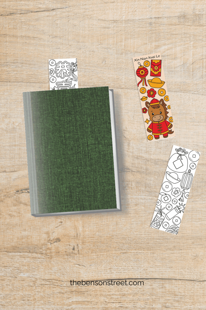 Free to print and color Lunar chinese New year bookmarks on a table and one in a book