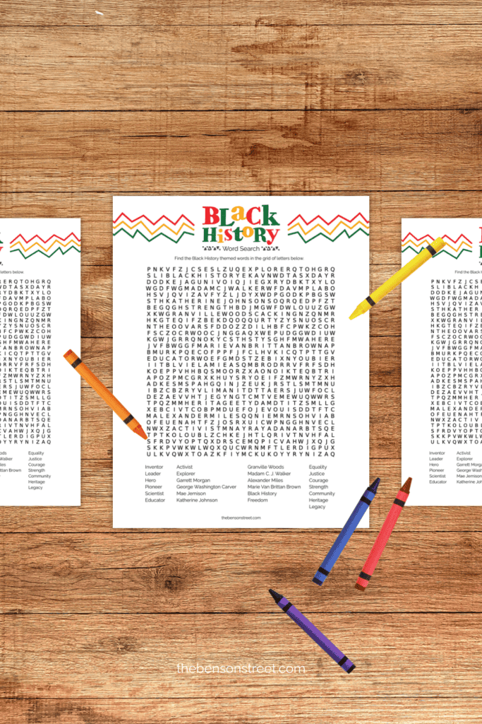 Printed out African American History Word Search pages on a table with crayons