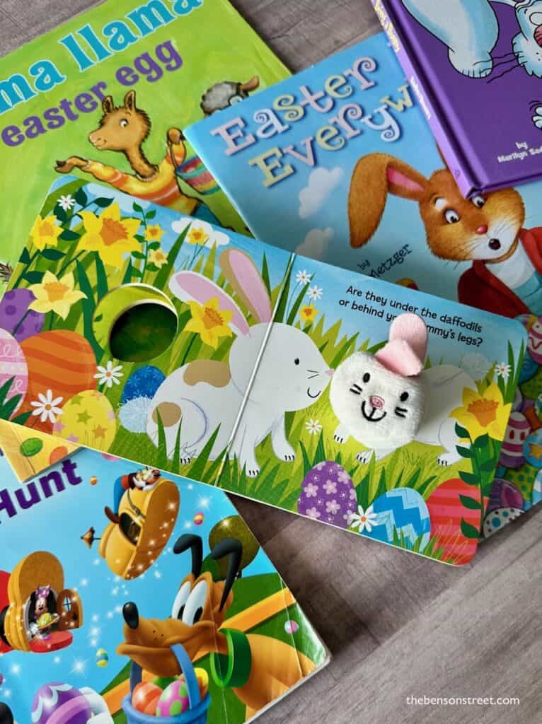 An open bunny book on top of other Easter books for kids