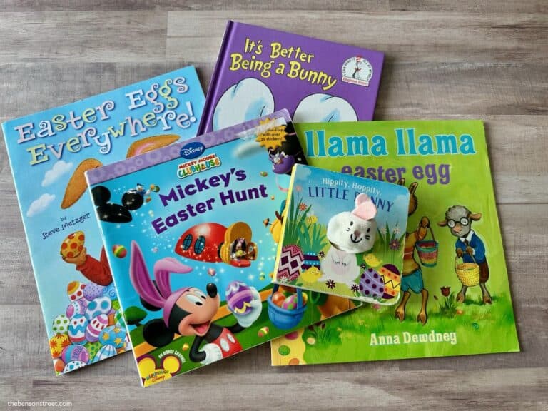 Five Easter themed books on a wood background for kids