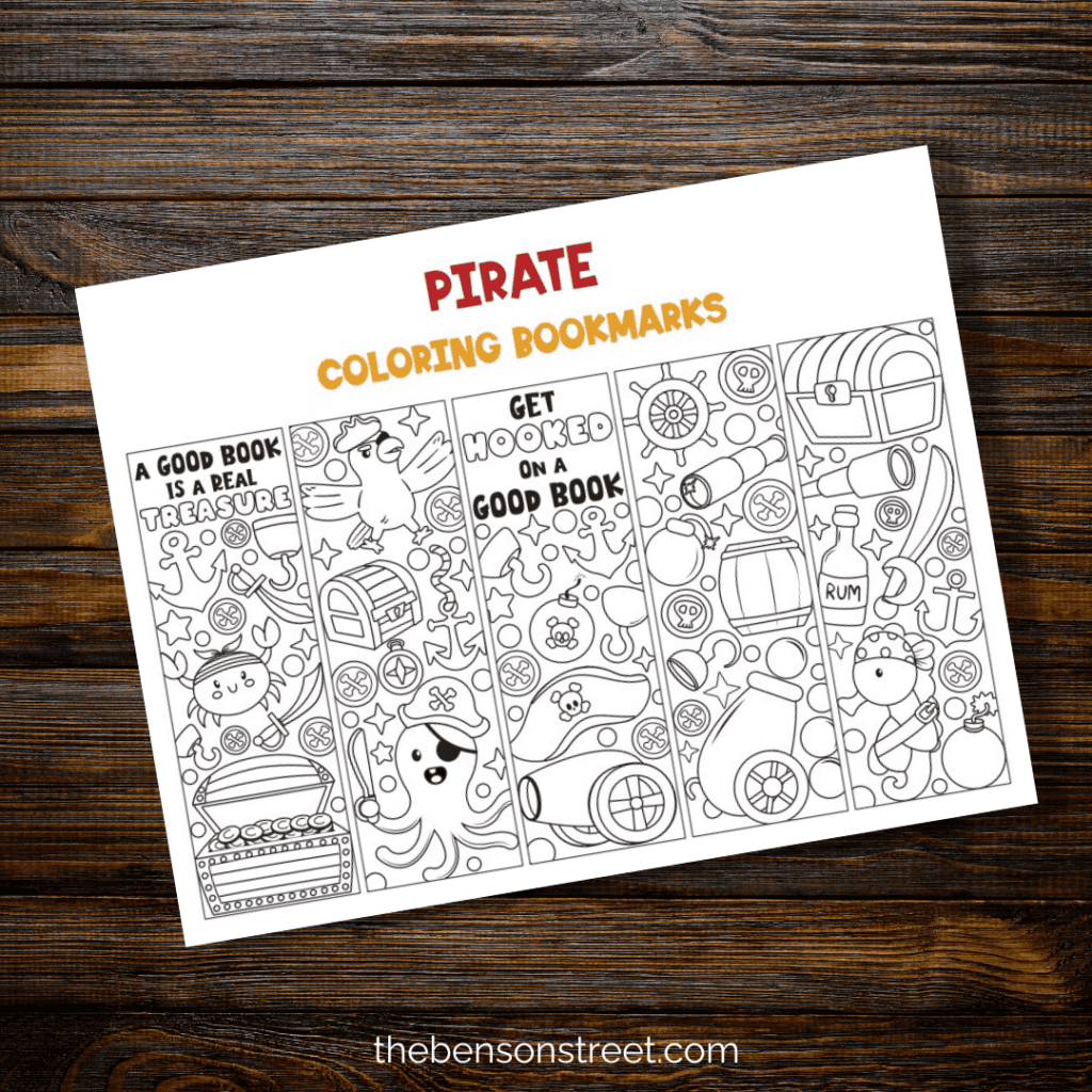 Pirate themed coloring bookmarks free printable sheet on a wood background 