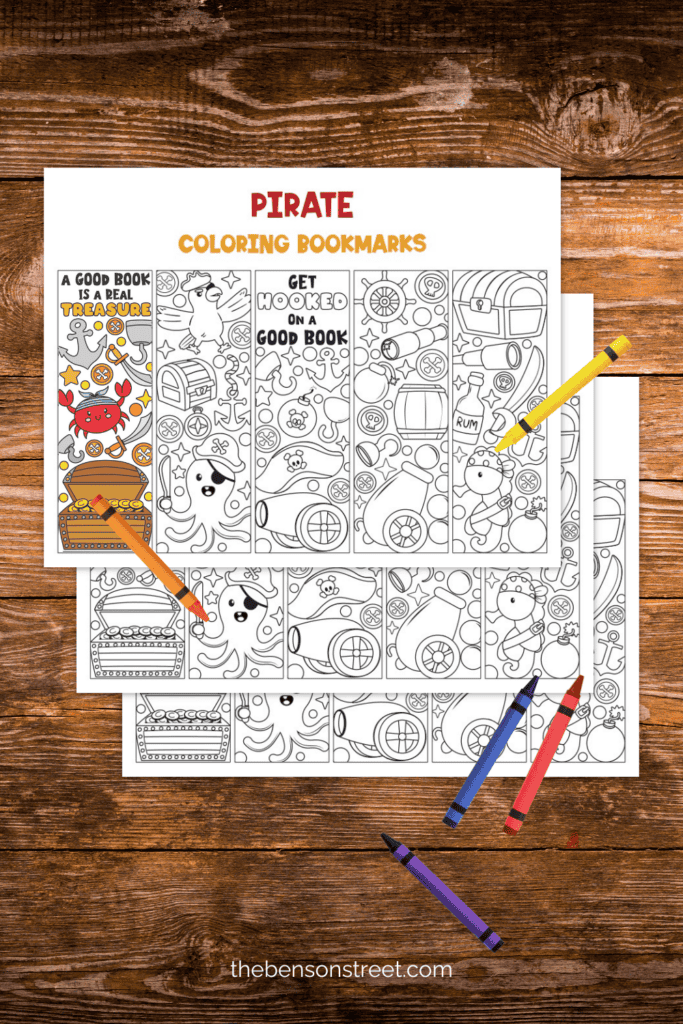 Three sheets of Pirate coloring pages with crayons on top