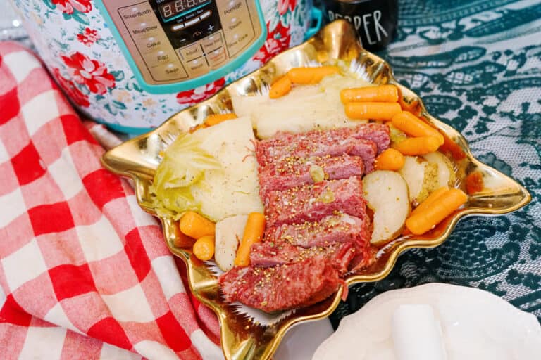 Cabbage, carrots, and potatoes with corned beef on a serving dish