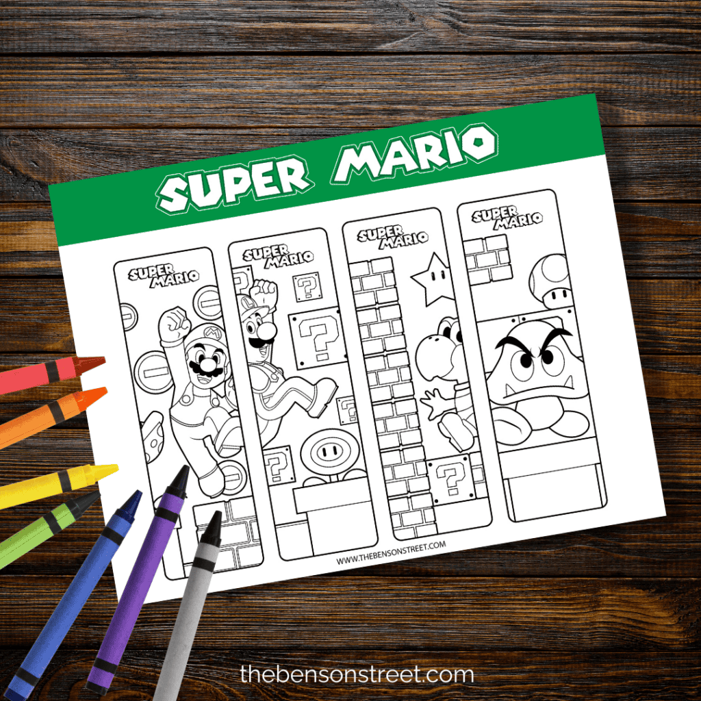 Page of Super Mario bookmarks on a wood background with crayons on top ready to color