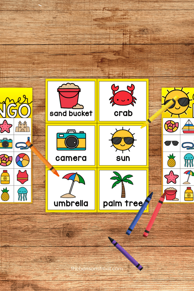 Summer bingo calling cards and boards with crayons laying around
