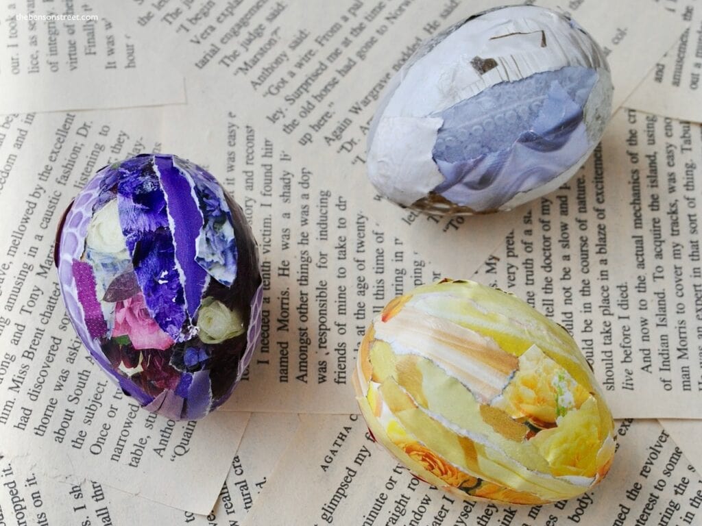 Three Easter eggs shot from above using magazine pieces