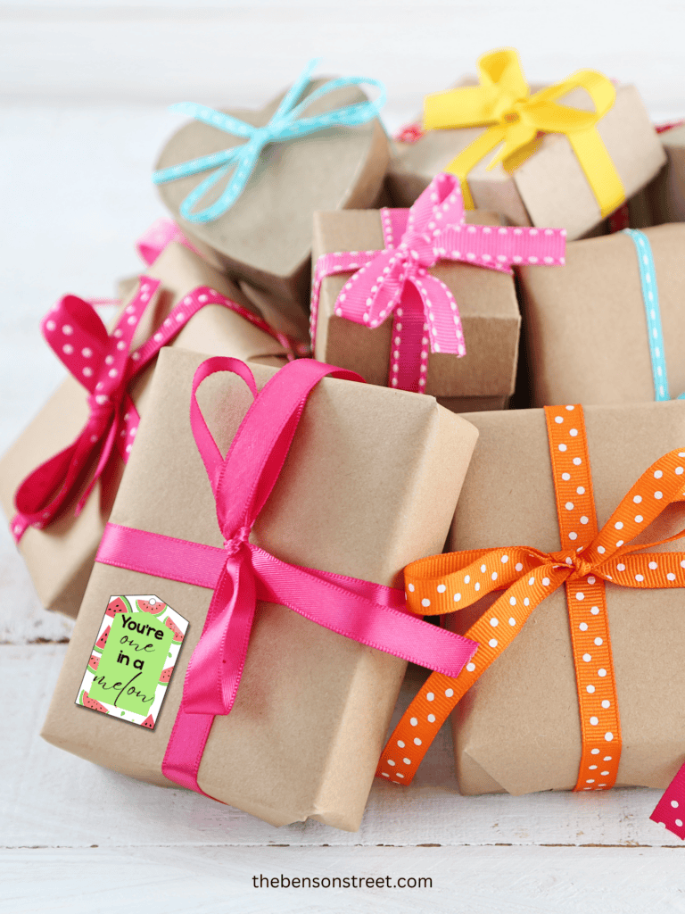 A bunch of gifts with a you're one in a melon tag on one