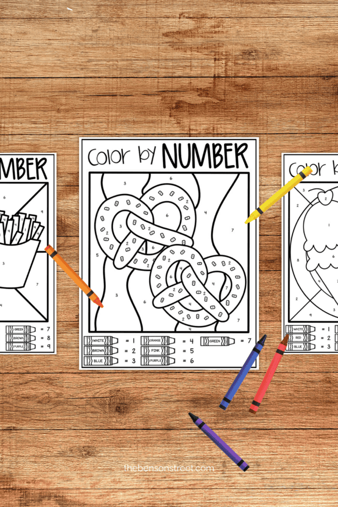 Table with printed out coloring pages of snacks with crayons on top