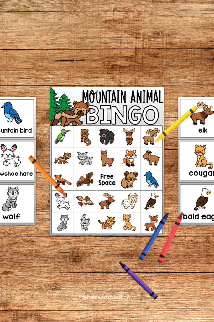 A mountain animal bingo board with calling cards and crayons on the side