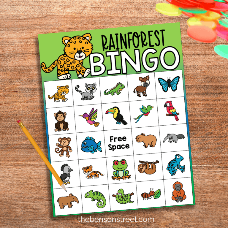 A page of rainforest bingo with animals on the squares with bingo chips and a pencil