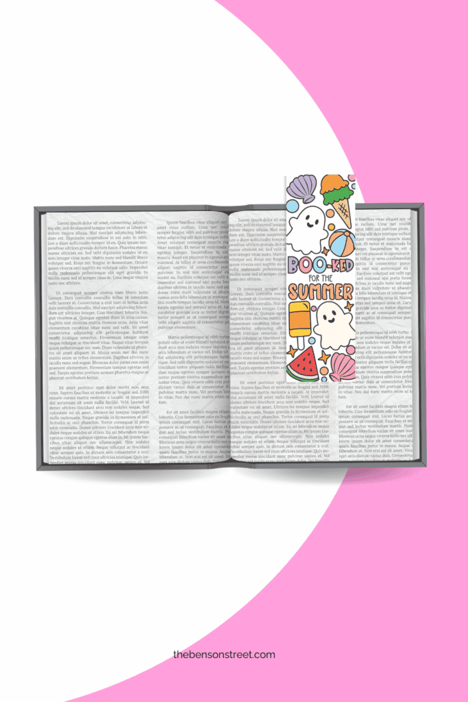 An open book with a summerween booked for the summer ghost bookmark on it