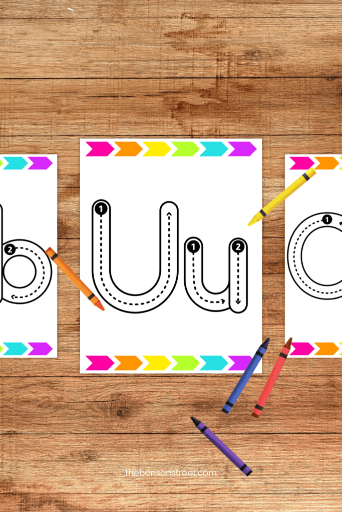 Letter playdough mats on a table with some crayons laying around 
