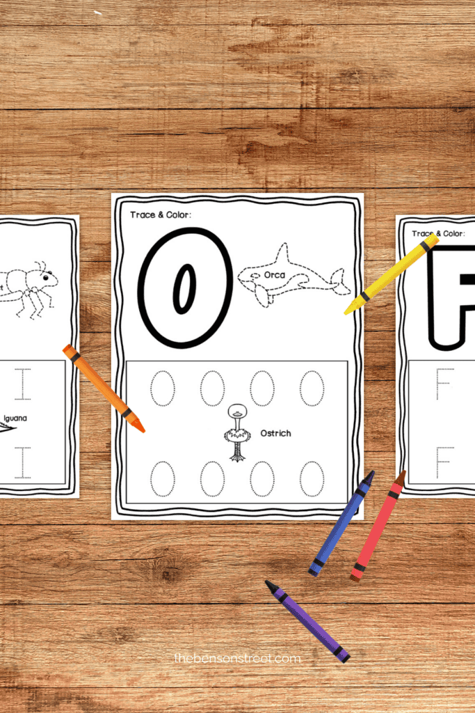 trace alphabet worksheet free printable pages on a table with crayons around