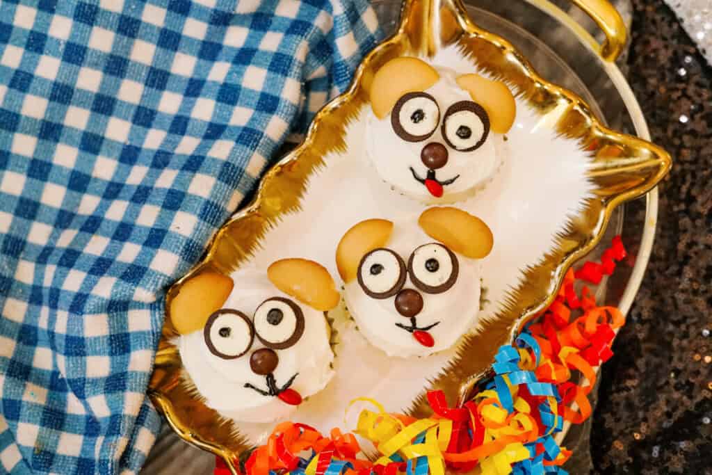 Overhead shot of three puppy cupcakes on a tray
