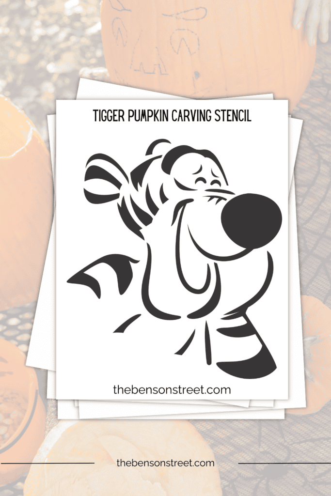 A laughing tigger face stencil pumpkin pattern free to print sheet on a stack of papers