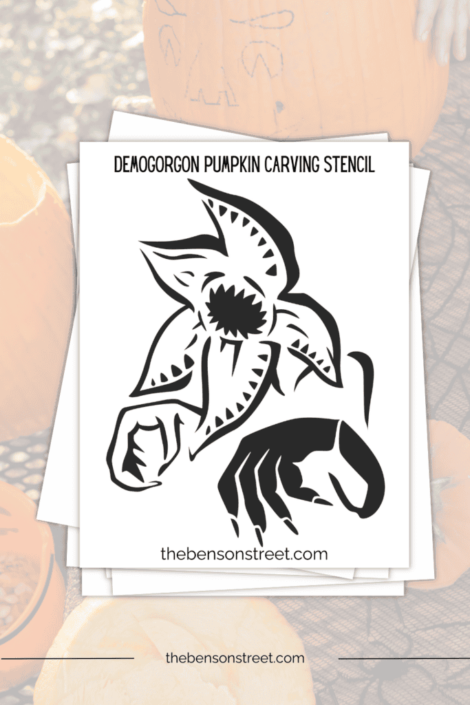 A stack papers with a black and white outline of demogorgon on top 