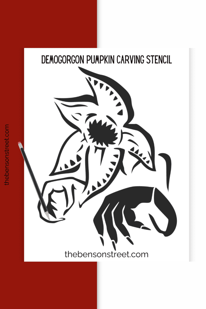 A stencil for carving a demogorgon pumpkin with a pencil laying on top