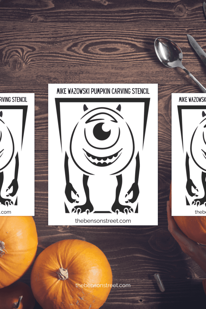 A table with pages of a one eyed monster on top for a pumpkin carving stencil 