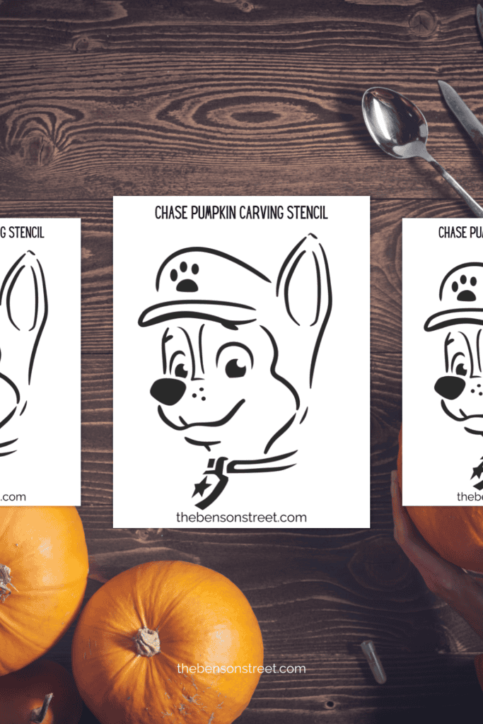 A table with pumpkins, carving tools and stencils with a dog face on them